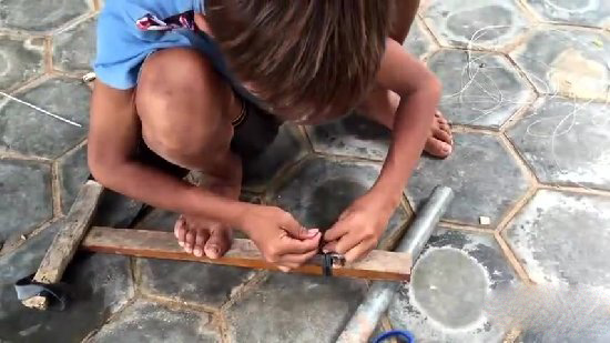 小孩自制捕鱼神器 竟意外捉到一大家伙（图）